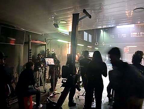 Atmospheric night set with lighting and full crew